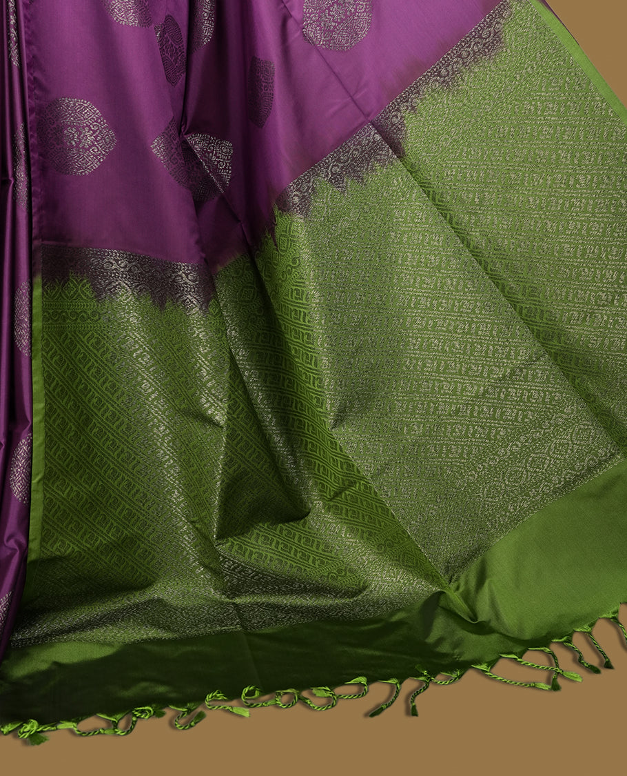 Purple colour semi soft silk saree, beautifully designed with self woven motifs & The look is enhanced by a rich contrast green border and pallu, paired with a matching blouse.