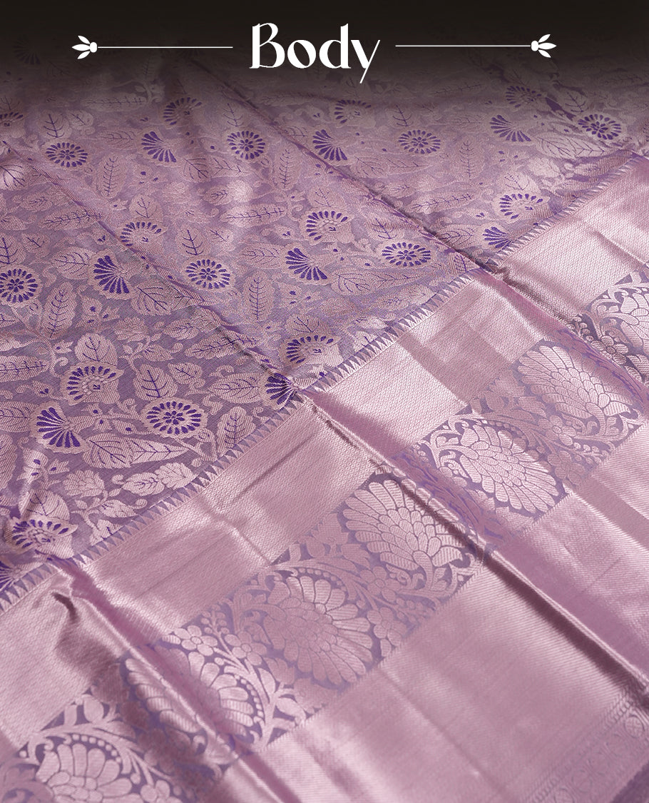 Lavender colour and Antique silver Zari Tissue Brocade Saree features intricate a navy blue coloured floral Motifs on body and A rose gold traditional border & pallu with floral patterns, paired with matching blouse