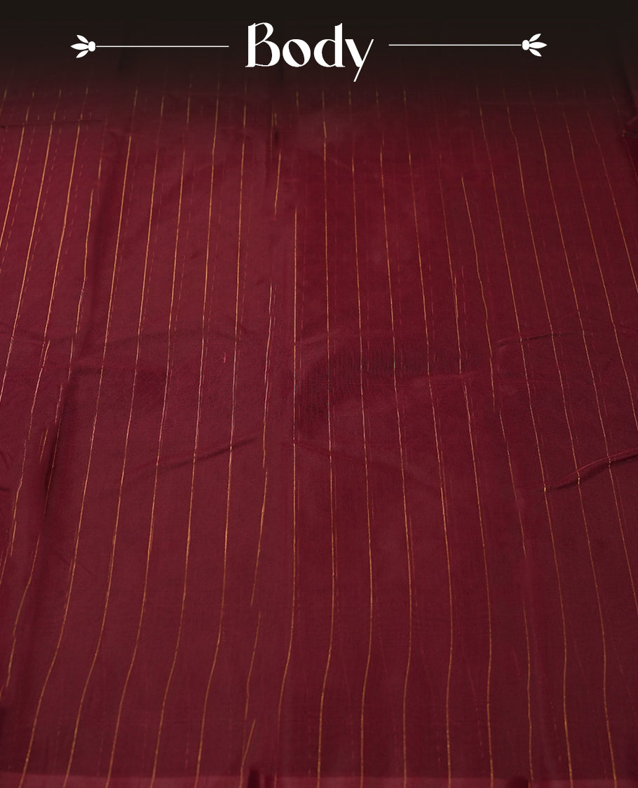 Maroon colour silk cotton saree featuring with delicate vertical copper zari lines on the body, Crafted without a border for a classy touch , Navy blue colour contrasted pallu & Comes with a matching blouse.