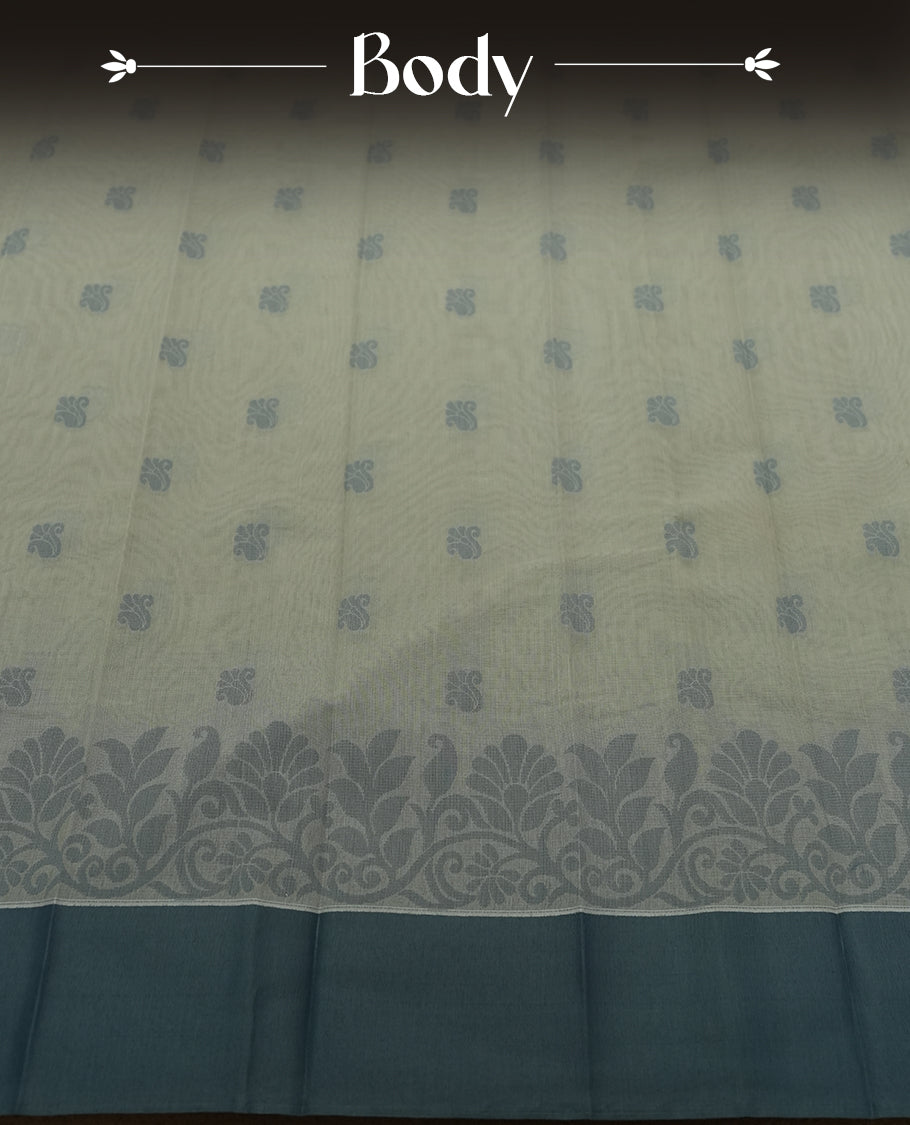 Grey colour silk cotton saree featuring elegant floral zari motifs on the body, complemented by a rich contrast border and pallu with traditional woven detailing & Comes with a matching blouse piece.
