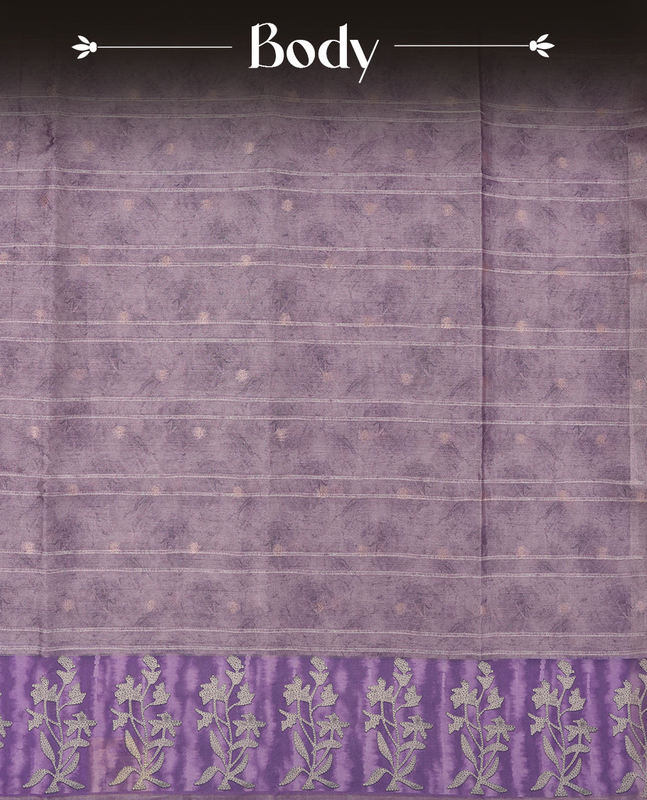 Light lavender colour semi tussar saree adorned with Cream strip printed pattern across the body, with cream Floral pattern on contrast Light purple colour border, paired with a matching blouse.