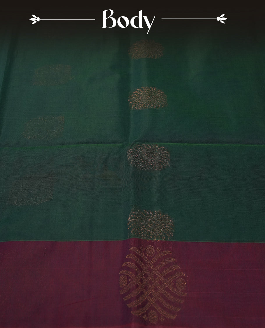 Deep greeen colour soft silk cotton saree adorned with copper zari motifs and a shimmering copper zari border, Enhanced by a beautifully rich maroon colour woven pallu & Comes with a matching blouse piece for a complete look.