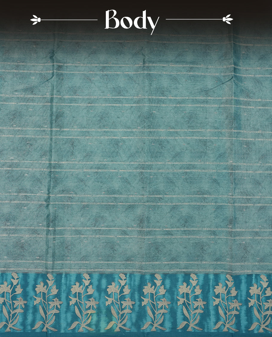 Light Aqua Blue colour semi tussar saree adorned with Cream strip printed pattern across the body and Floral pattern contrast Aqua Blue colour on border, paired with a matching blouse.