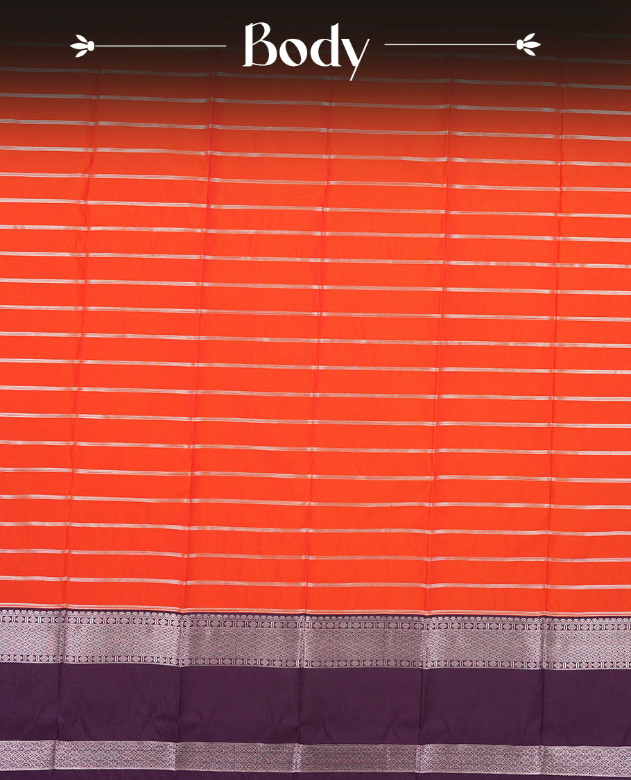 Orange red colour Semi Silk Saree with gold zari striped patterns on the body, paired with a contrasting Dark violet colour traditional pallu and border, and a matching blouse piece.
