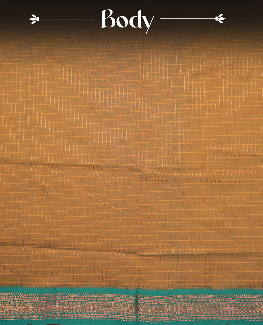 Mustard yellow coloured mixed Kalyani cotton saree featuring copper zari checks on the body, complemented by a dusty green coloured border and pallu adorned with copper zari patterns, Paired with a matching blouse.