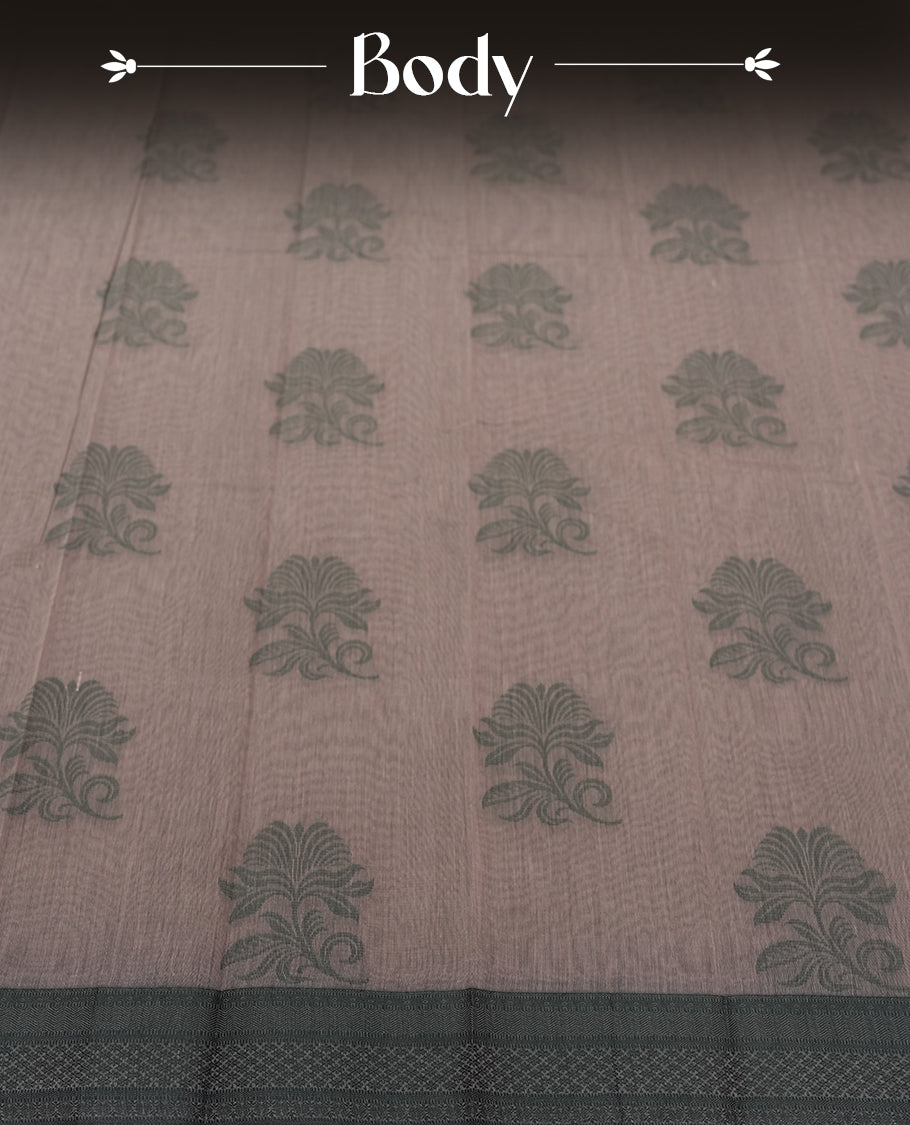 Dusty grey colour silk cotton saree featuring elegant floral zari motifs on the body, complemented by a rich contrast dark greenish border and pallu with traditional woven detailing & Comes with a matching blouse piece.