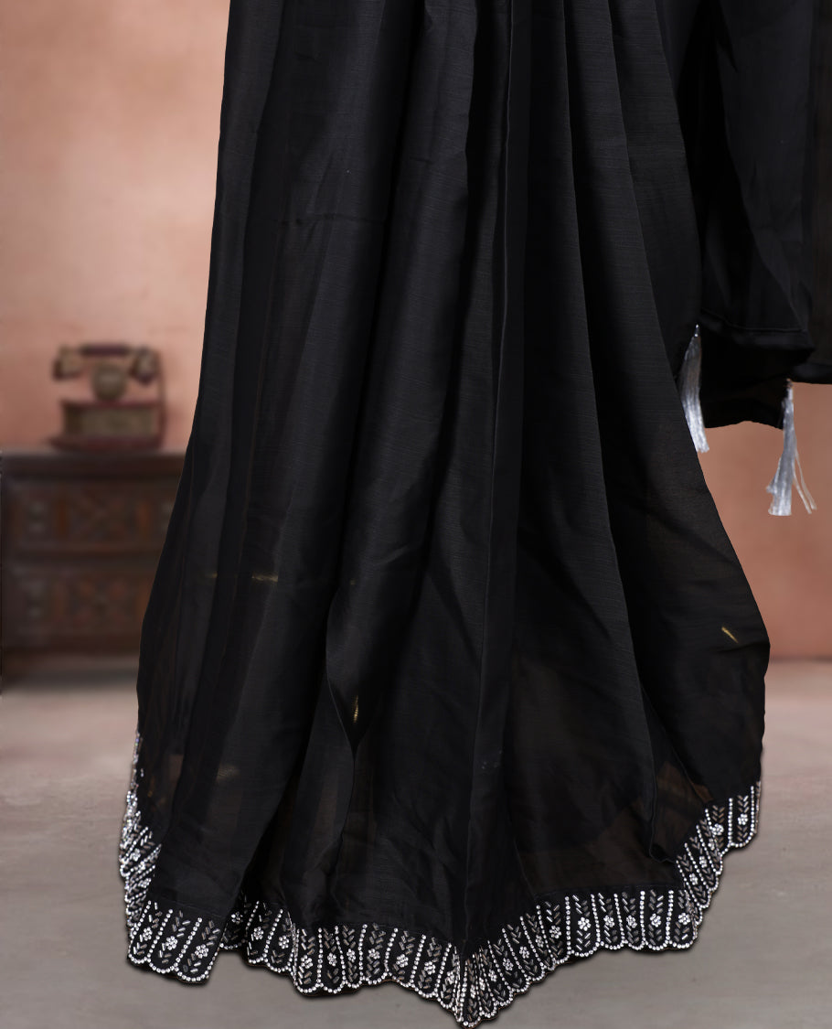 Elegant Black colour ready to wear saree adorned with rich silver stone and bead embroidery along the border and pallu, paired with a heavily embellished matching blouse for a grand festive look.