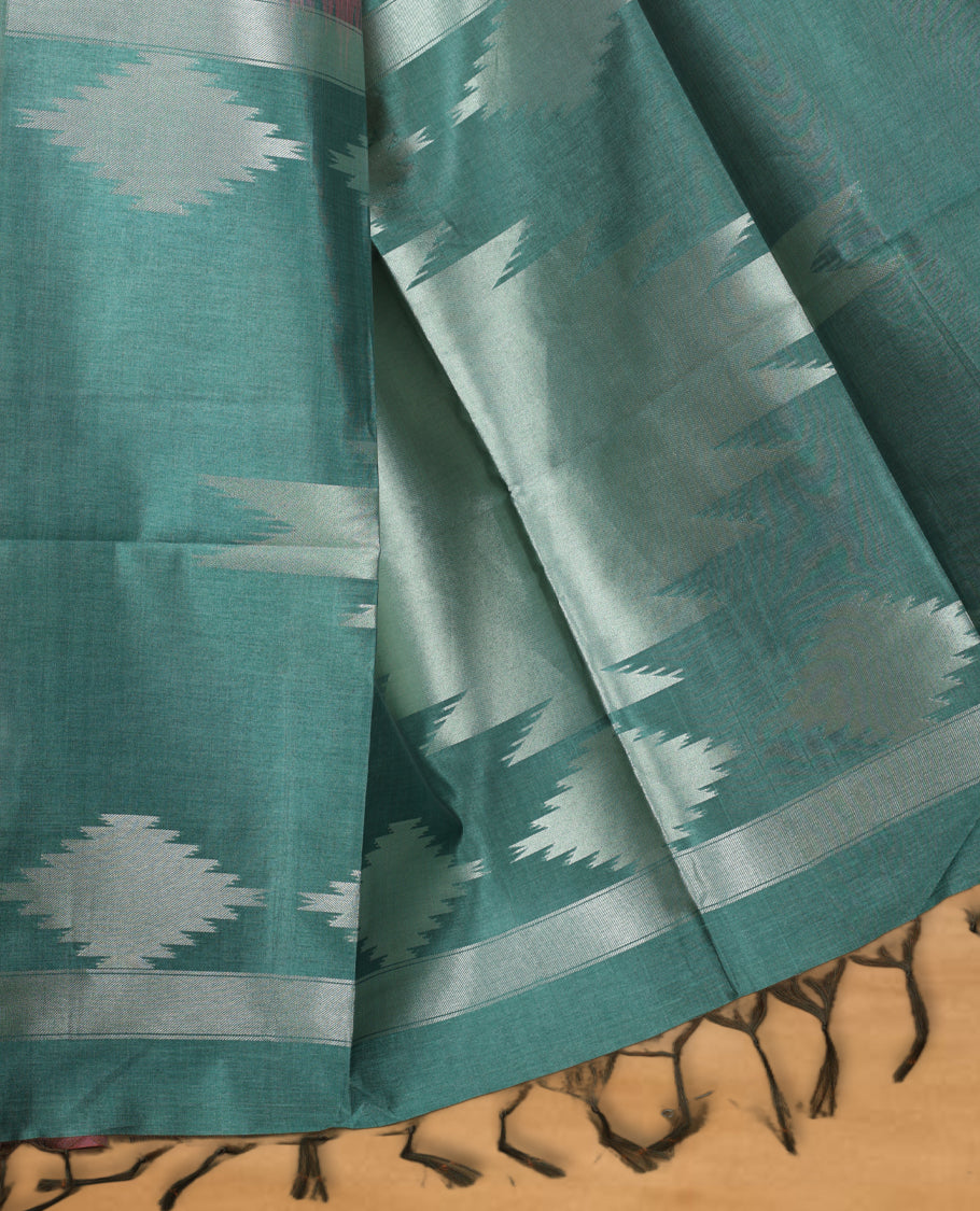 Pink and silver colour dual tone semi tussar saree featuring woven abstract geometric motifs on the body, complemented by a ikat inspired contrast Aqua green patterned pallu, paired with a matching blouse.