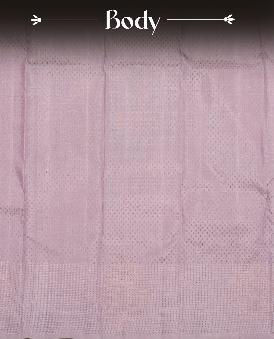 Dusty Lavender colour Vasundhara silk saree featuring self colour motifs across the body, finished with a self‑coloured tiny daimond pattern with gold tree motifs on border and a coordinating blouse.