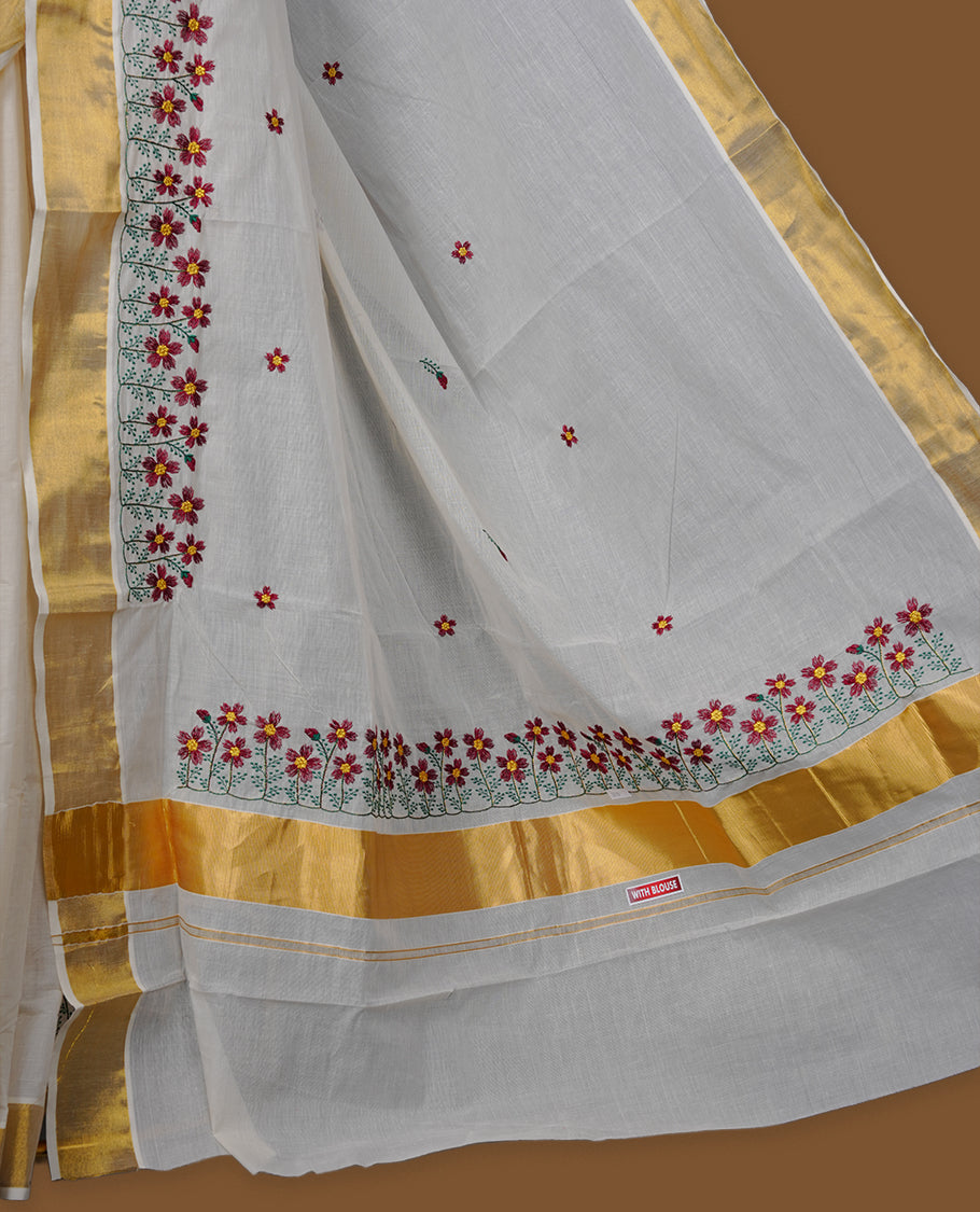 Off-white colour Kerala saree with a classic gold kasavu border, delicately embroidered floral motifs in red and green across the body and pallu, finished with a subtle golden sheen for timeless elegance.