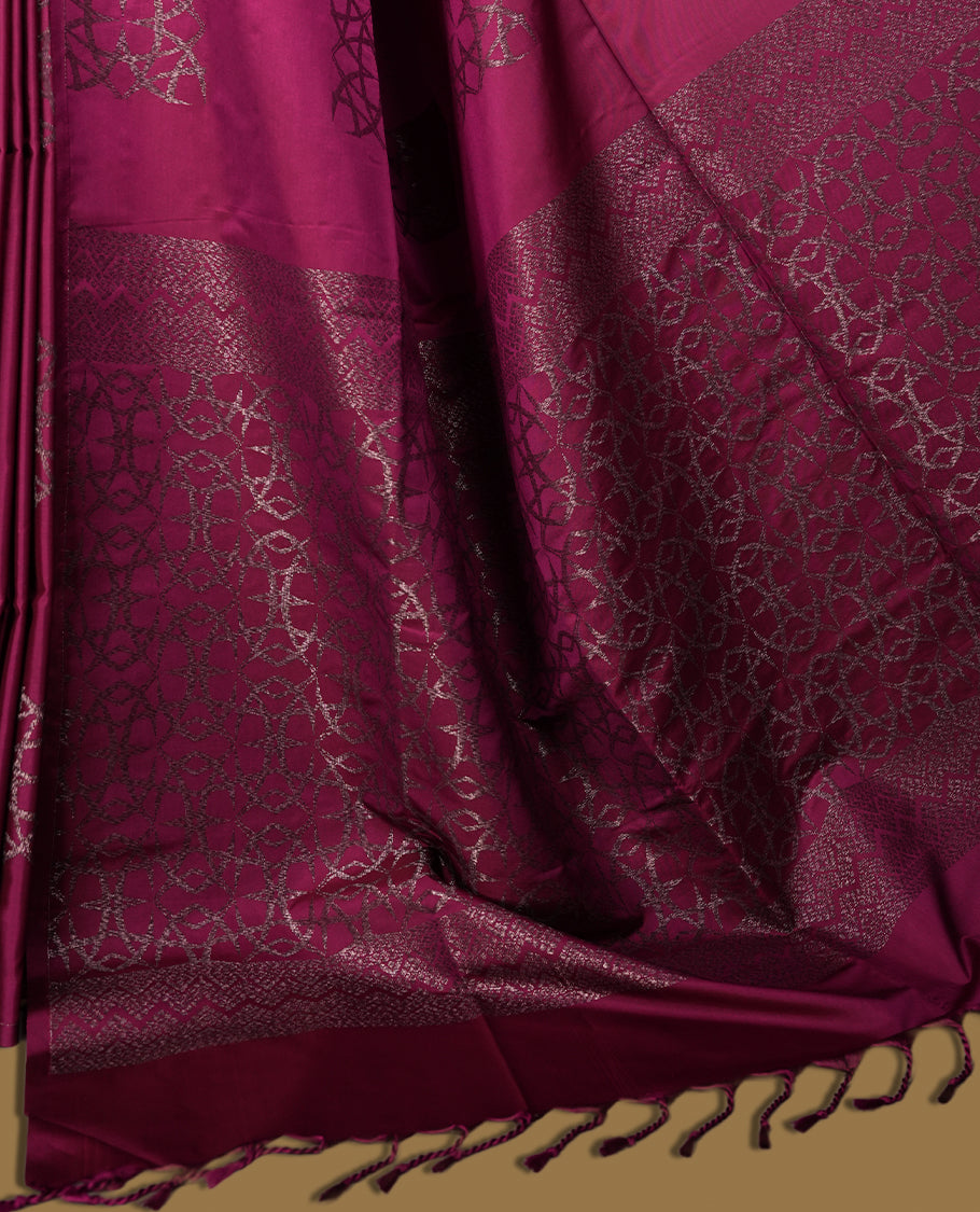 Wine colour semi soft silk saree, adorned with subtle self woven motifs on the body & The design is elevated with an elegant zari border and pallu, paired with a matching blouse.
