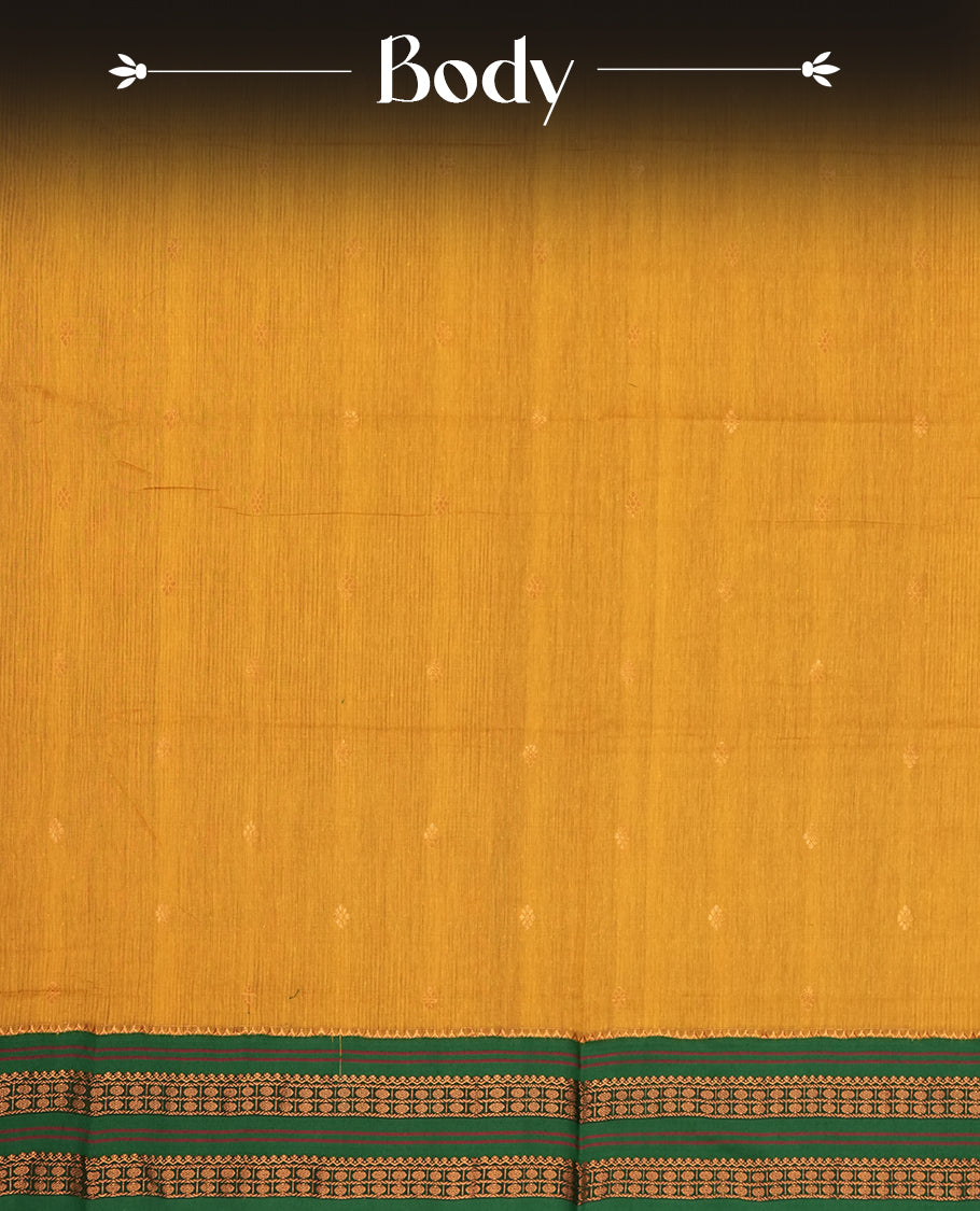 Mustard yellow Kalayani cotton saree with delicate woven motifs on the body, enhanced by a rich green zari border and pallu with traditional patterns, paired with a matching blouse piece.