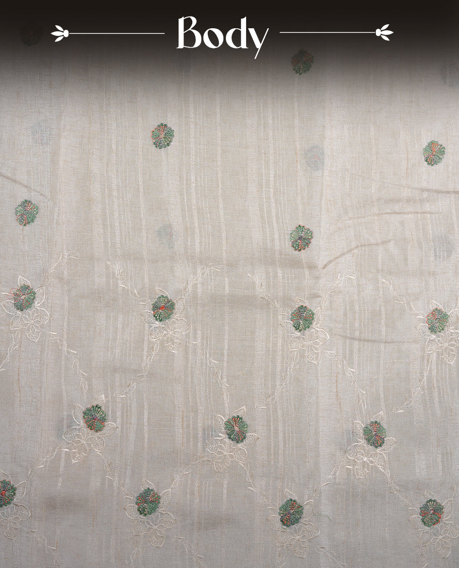 Cream colour semi tuseer silk saree featuring with Self colour thread embroidery kodi pattern & green colour floral thread motifs all over body, pallu, and paired with matching blouse piece.