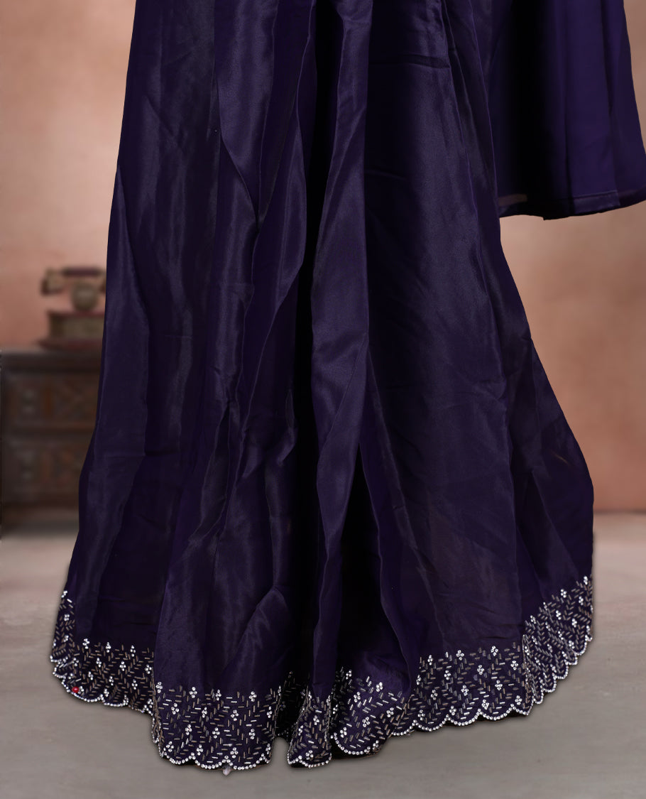 Elegant deep purple colour ready to wear saree adorned with rich white stone and bead embroidery along the border and pallu, paired with a heavily embellished matching blouse for a grand festive look.