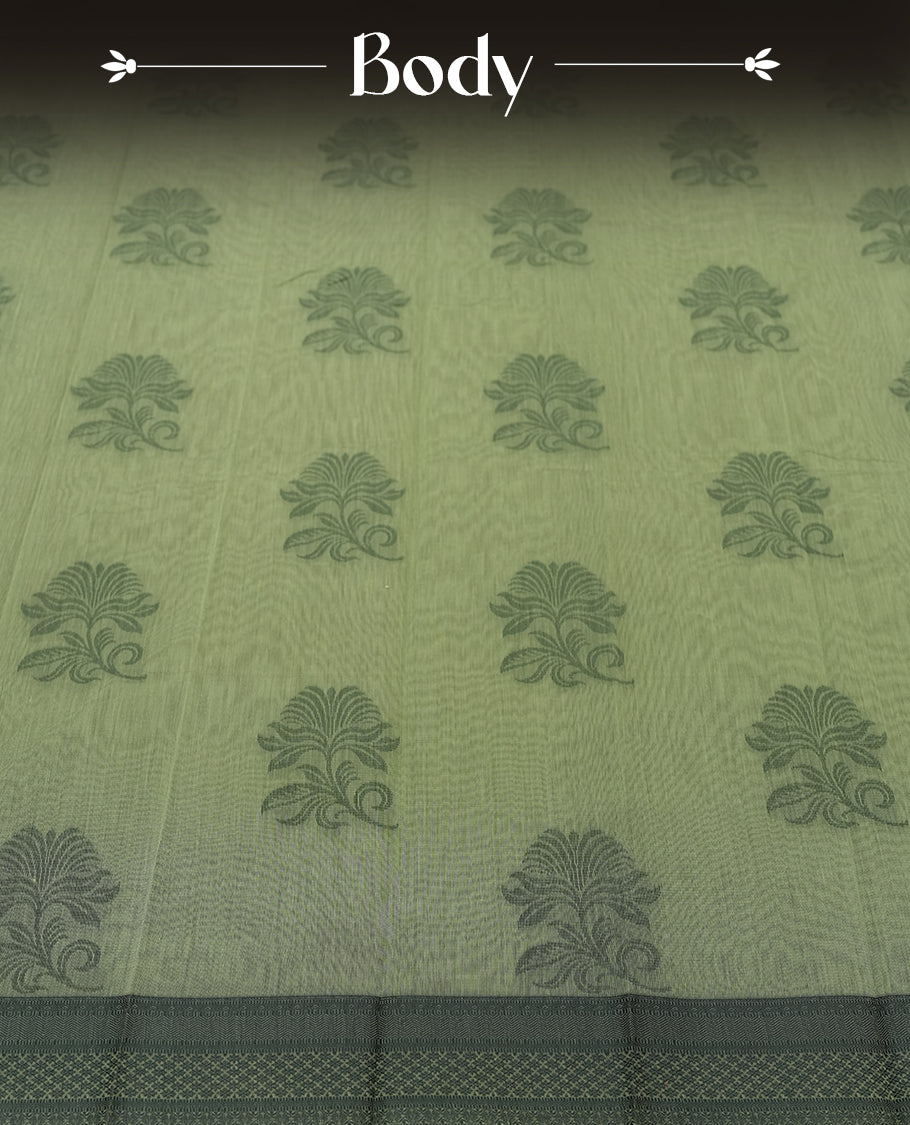 Pastel green colour silk cotton saree featuring elegant floral zari motifs on the body, complemented by a rich contrast dark green border and pallu with traditional woven detailing & Comes with a matching blouse piece.