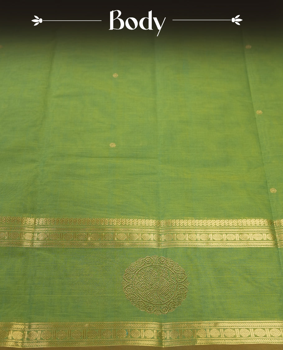 Fern Green colour Pure Kanchi cotton saree featuring delicate golden buttas and a rich zari border with intricate motifs & Paired with a matching blouse, it exudes timeless elegance, perfect for festive and traditional occasions.