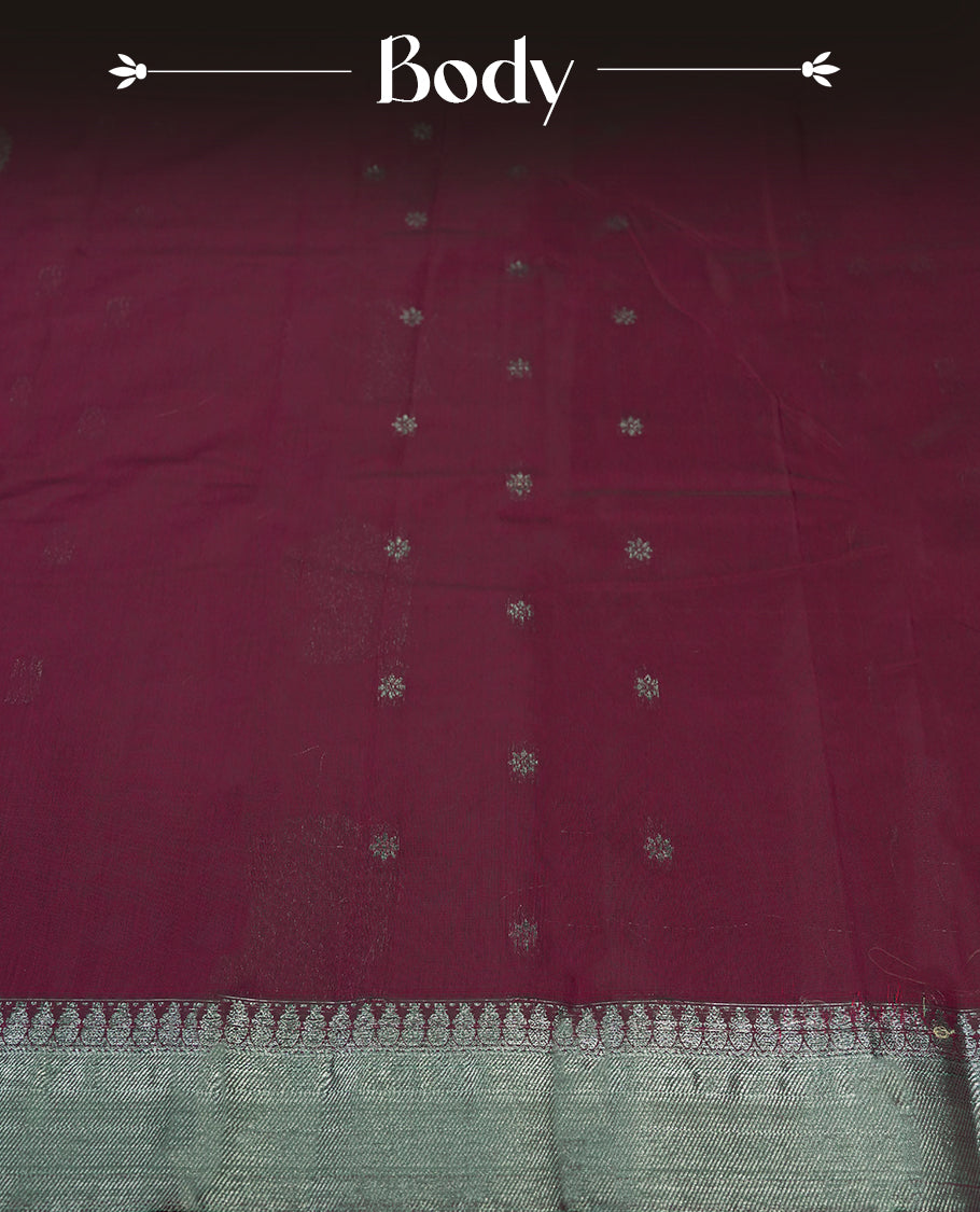 Magenta colour silk cotton saree adorned with a shimmering silver zari border and intricate woven designs, blending elegance with tradition, Paired with a matching blouse, its perfect for festive and special occasions.