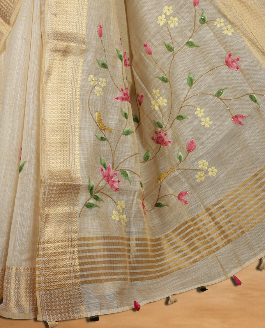Beige colour Banarasi linen silk saree featuring hand brushed colour with Floral & birds printed pattern on body, gold zari woven geometric design border with self colour pallu and comes with a matching blouse