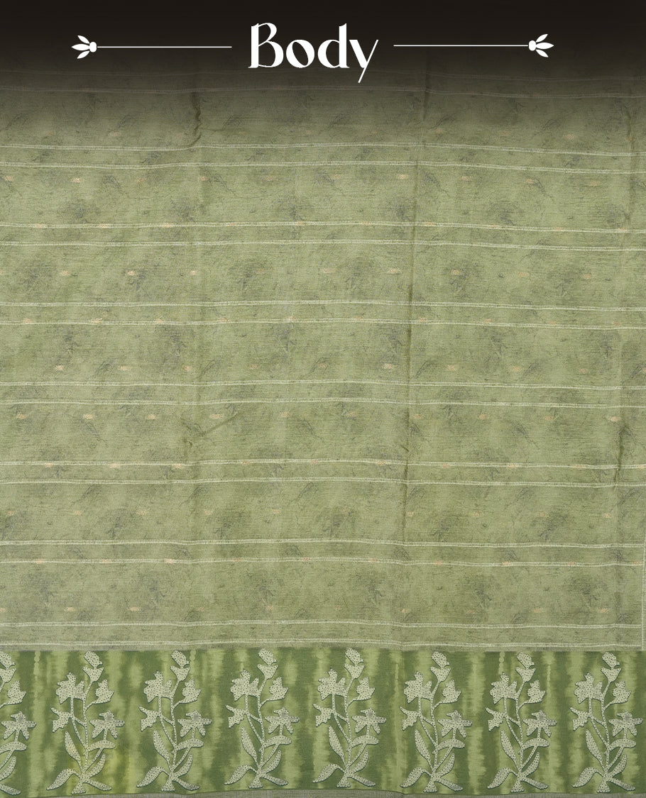 Sage green colour semi tussar saree adorned with Cream strip printed pattern across the body and Floral pattern contrast fern green colour on border, paired with a matching blouse.