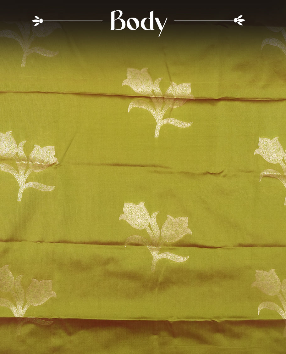Olive Green colour semi silk saree adorned with floral motifs on the body, complemented by a shimmering golden zari-woven pallu and border, and paired with a matching blouse