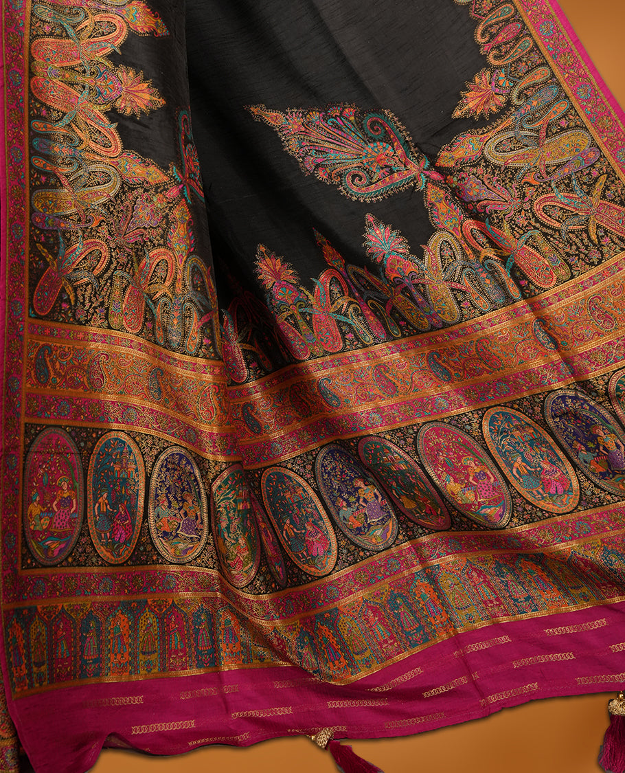 Black colour Pashmina silk saree densely woven with intricate multicolour floral and architectural motifs across the body, framed by an opulent arabesque border and grand storytelling pallu, paired with a matching black woven border blouse piece