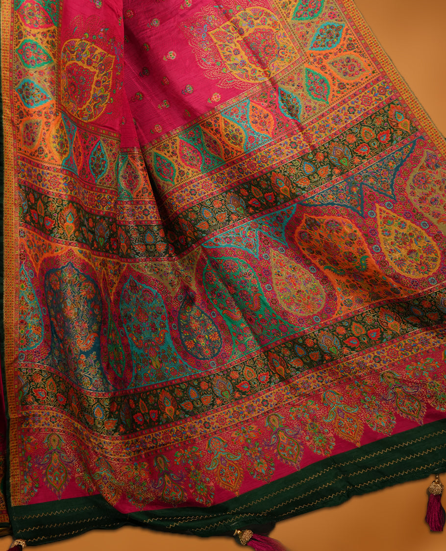 Rani Pink colour Pashmina silk saree densely woven with intricate multicolour floral motifs across the body, framed by an opulent arabesque border and grand storytelling pallu, paired with a matching woven border blouse piece