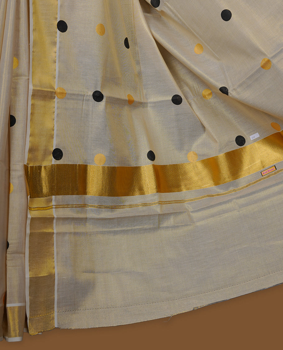Off-white colour Tissue Kerala saree featuring playful black and gold polka buttas across the body, finished with a classic gold kasavu border and paired with a matching blouse.