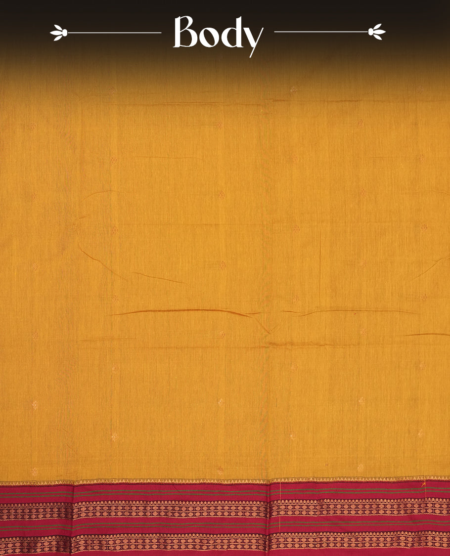 Mustard yellow Kalayani cotton saree with delicate woven motifs on the body, enhanced by a rich maroon contrasted zari border and pallu with traditional patterns, paired with a matching blouse piece.