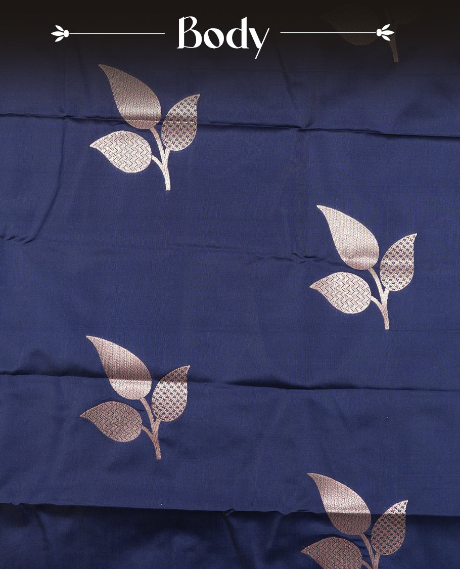 Dark blue colour semi silk saree adorned with elegant floral motifs on the body, complemented by a shimmering golden zari-woven pallu and border, and paired with a matching blouse