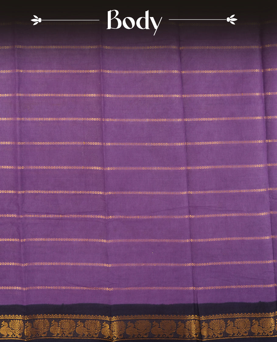 Purple colour Chettinad cotton saree adorned with subtle golden zari stripes all over, The contrast black border features intricate peacock and floral motifs & Comes with a matching blouse piece.