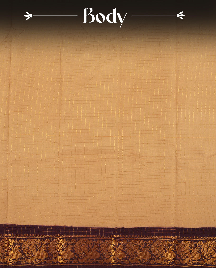 Beige colour Chettinad cotton saree adorned with subtle checked patterns on the body, complemented by an exquisite dark maroon border featuring golden peacock motifs & Paired with a matching blouse piece.