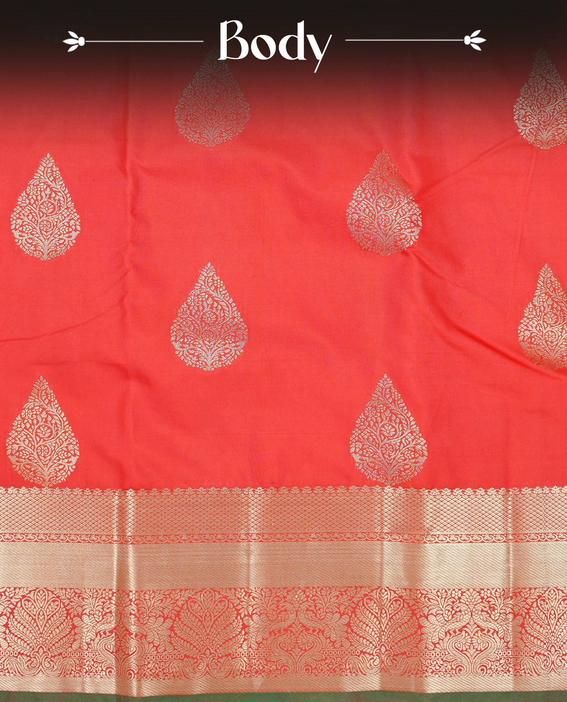Red Colour semi wedding silk saree featuring Gold zari leaf motifs on body, complemented by Traditional zari on self colour border with green colour piping, paired with matching blouse piece.