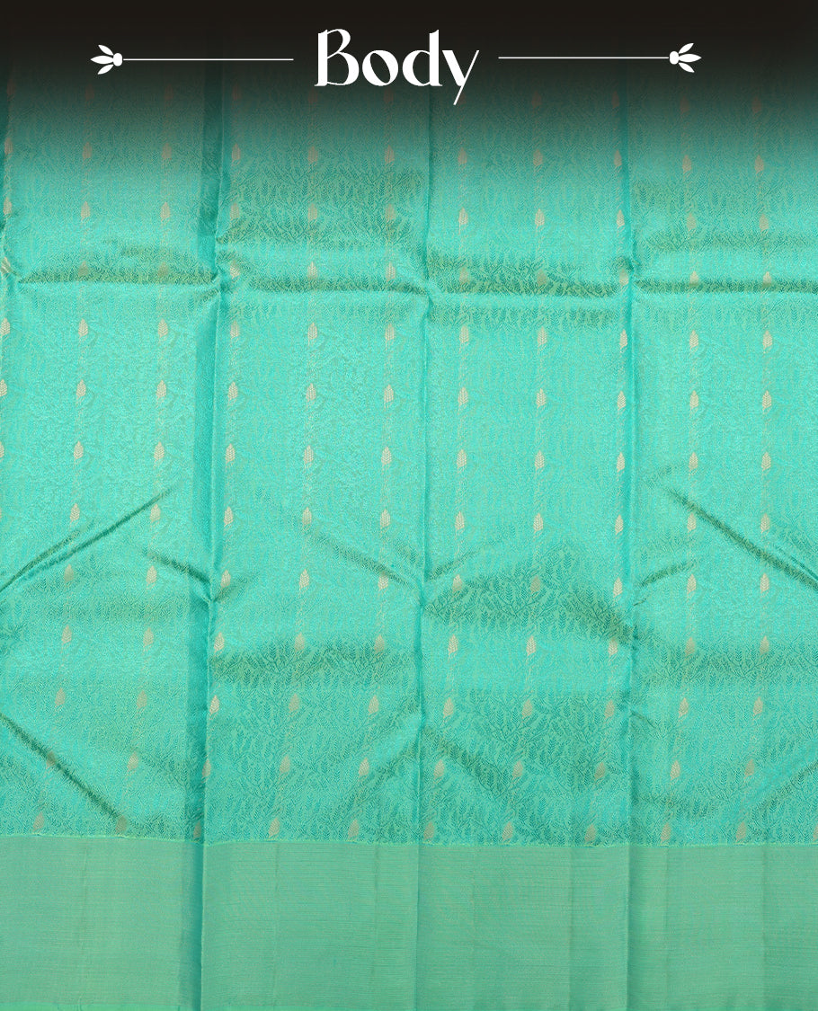 Aqua Green colour Vasundhara silk saree adorned with all-over green flower kodi motifs on the body, complemented by a self colour with gold Line pattern border and paired with a matching blouse piece.