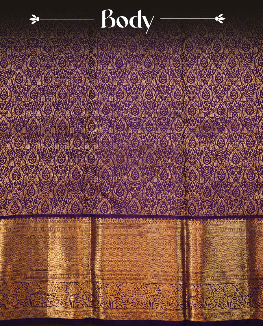 Indigo colour kancheepuram silk saree featuring gold zari floral kodi pattern on body, complemented by self colour with traditional border, paired with matching blouse piece.