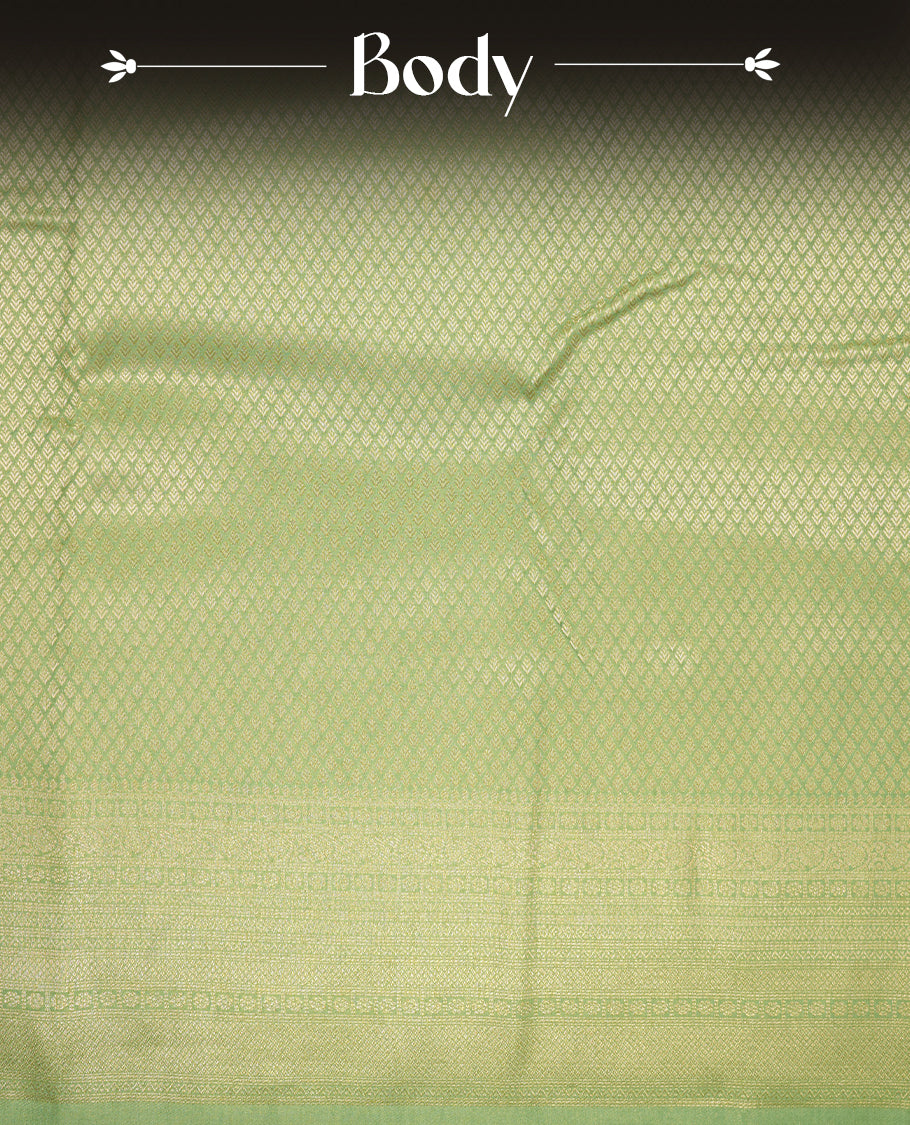 Pastel green colour semi soft silk saree featuring gold zari motifs on across body, self colour border with traditional gold zari pattern, pallu and paired with matching blouse.