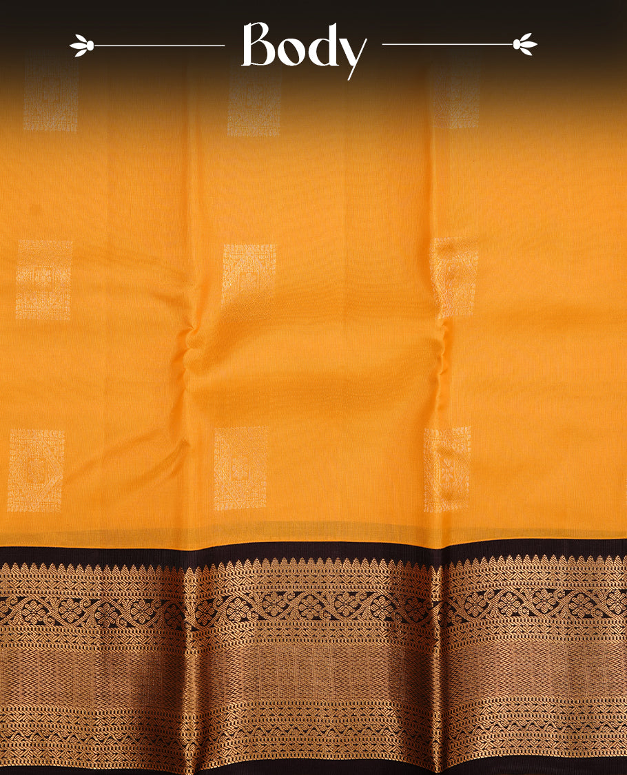 Mustard colour traditional kancheepuram silk saree featuring gold zari motifs on body, complemented by contrast black colour with gold zari traditional border, paired with matching blouse piece.