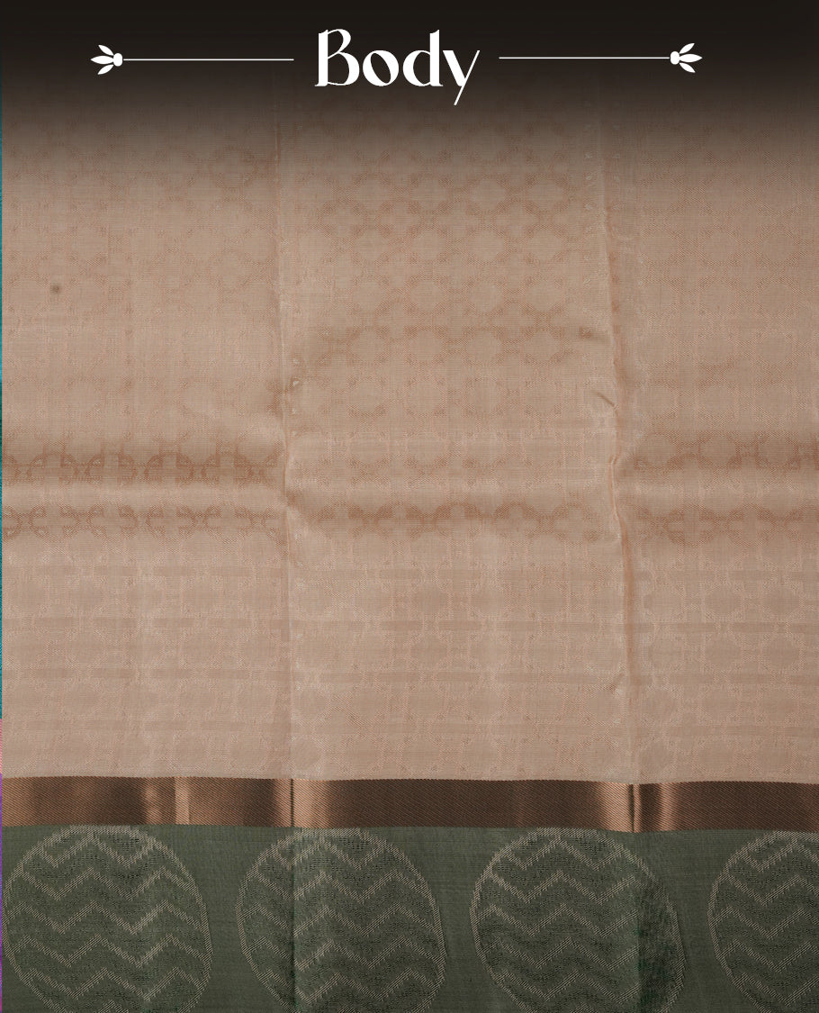 Cream colour soft silk saree featuring gold zari floral motifs on the body, complemented by a contrast green zari floral kodi border and pallu, paired with a matching blouse piece.