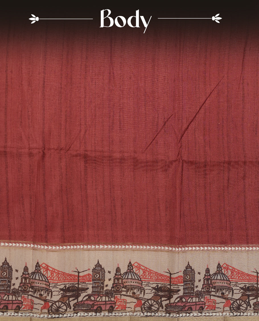 Brick red colour semi tusser silk saree featuring contrast cream colour London bridge printed pattern border and paired with matching blouse.