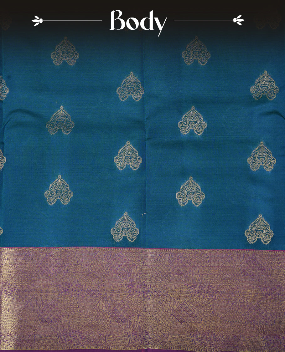 Peacock colour Soft silk saree featuring gold zari motifs on the body, complemented by a contrast indigo traditional zari border and pallu, paired with a matching blouse piece.