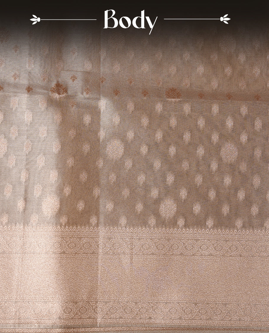 Pastel grey colour semi tissue silk saree featuring floral zari motifs on body, complemented by gold zari traditional border, paired with matching blouse piece.