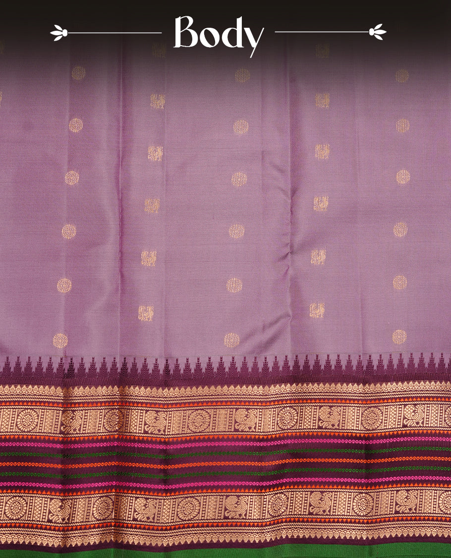 Lavender colour traditional kancheepuram silk saree featuring gold zari motifs on body, complemented by contrast multicolour with gold zari traditional border, paired with matching blouse piece.