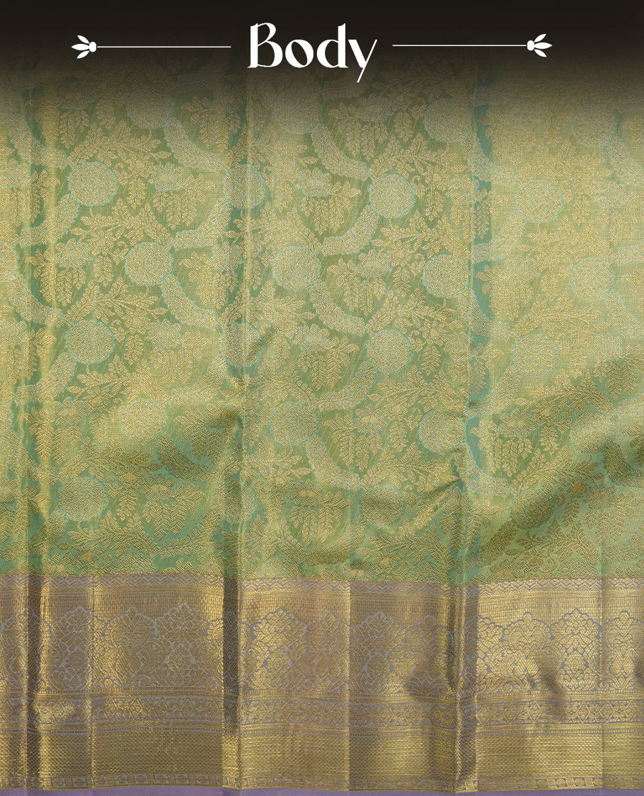 Light pastel green & gold double shade colour kancheepuram tissue silk saree highlighting gold zari pattern body, with contrast lavender colour colour with traditional border and paired with matching blouse.