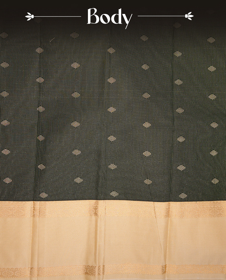 Dark green coloured soft silk saree featuring gold zari stripes and motifs across the body, enhanced with a contrast cream border and pallu, paired with a matching contrast blouse piece.