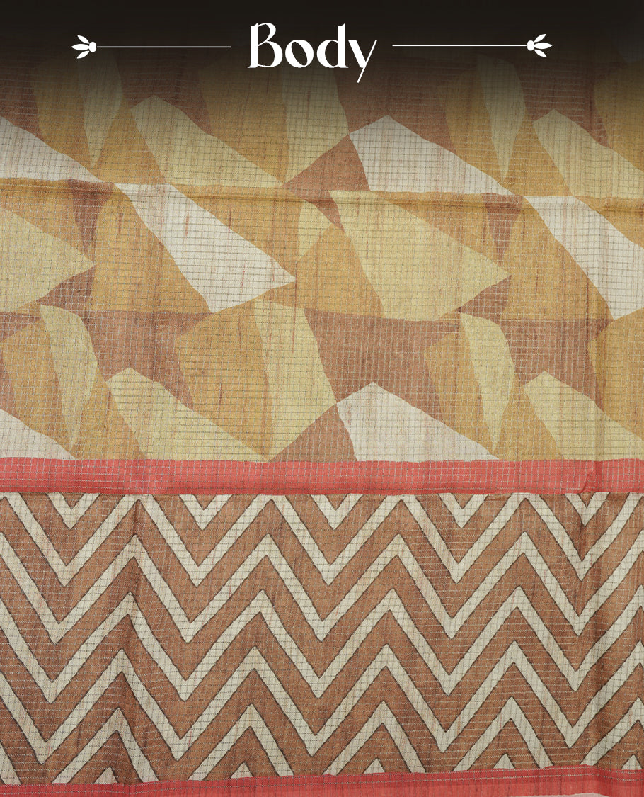 Rust brown colour semi tussar silk saree featuring bold zigzag geometric prints across the body, highlighted with a contrasting coral-red border and detailed pallu, paired with a matching printed blouse piece.