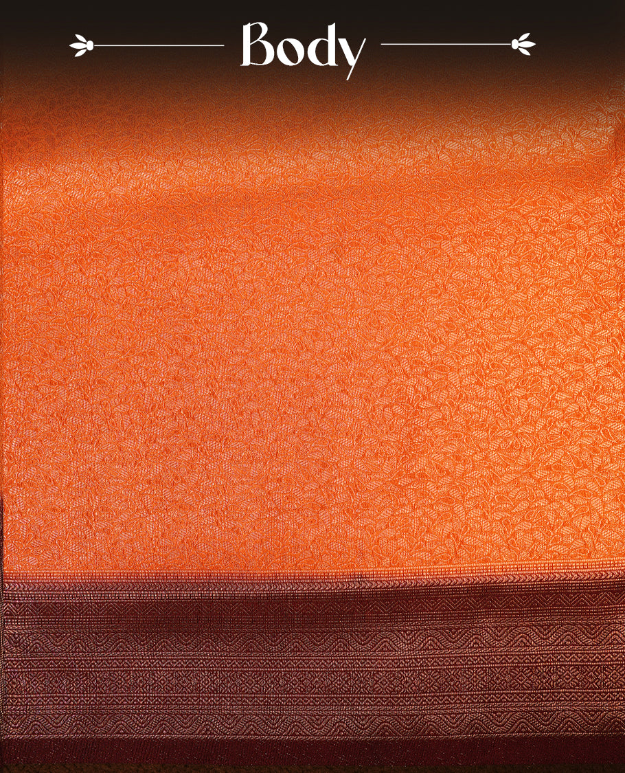 Rust orange colour softie silk saree featuring floral gold zari pattern across body, complemented by contrast chocolate brown with gold zari border, paired with matching blouse