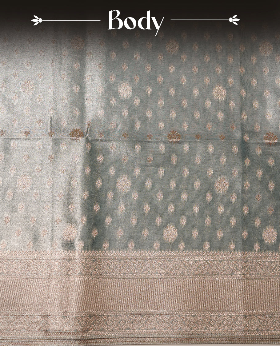Pastel Aqua colour semi tissue silk saree featuring floral zari motifs on body, complemented by gold zari traditional border, paired with matching blouse piece.