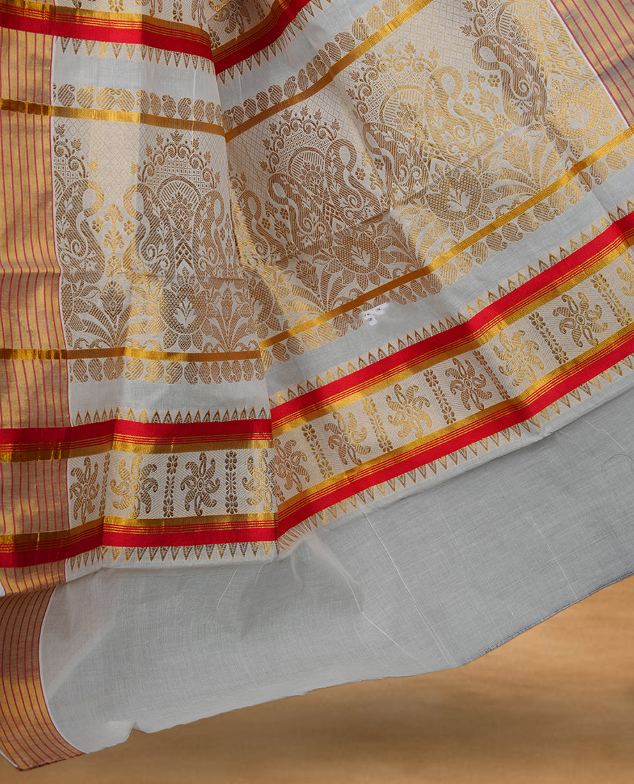 Off white colour cotton Kerala saree featuring subtle woven motifs, striped zari border with red detailing, and rich traditional zari pallu, paired with a matching blouse.