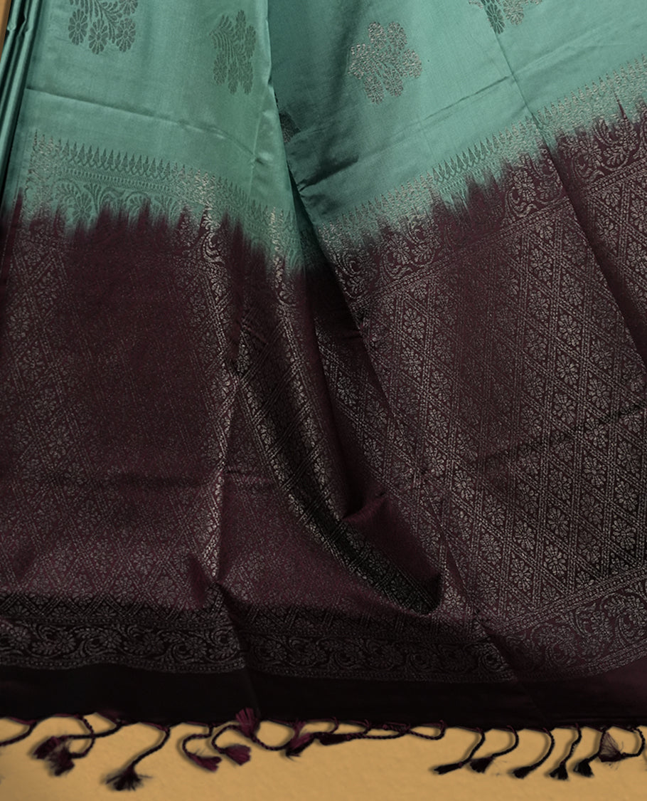 Turkish blue colour semi soft silk saree, beautifully designed with woven floral motifs & The look is enhanced by a rich contrast deep wine colour border and pallu with tassels, paired with a matching blouse.