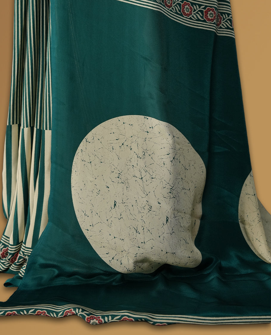 Teal and cream colour saree with bold stripes and geometric circle motifs, accentuated by a detailed ethnic border & paired with matching blouse.