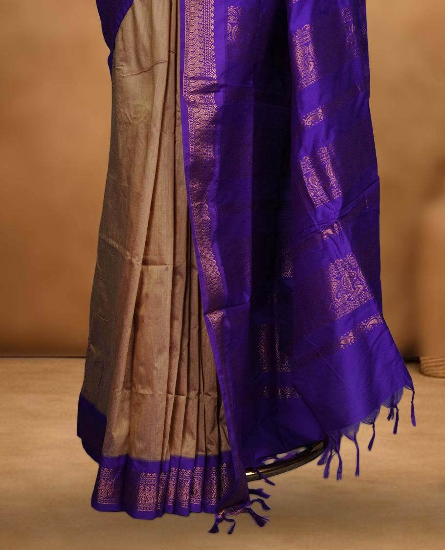 Antique gold colour Kalyani cotton saree featuring a plain elegant body, complemented by a rich Purple zari border and traditional woven pallu, paired with a matching blouse.